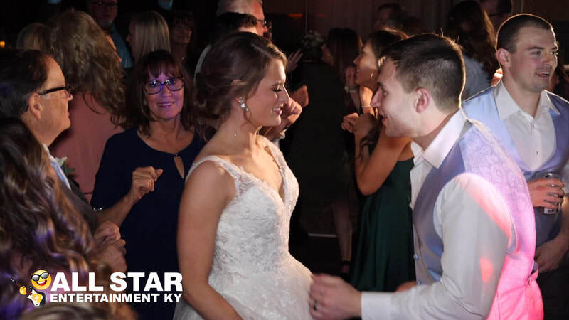 Bride and groom dancing with guests