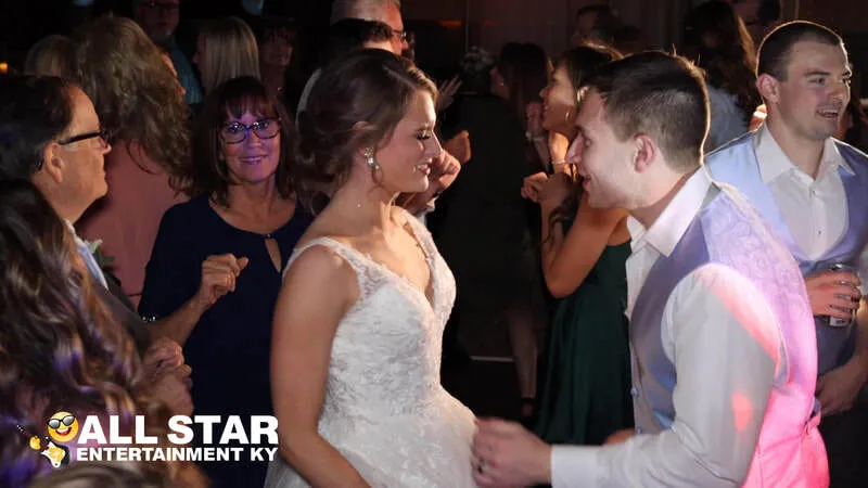 Bride and groom dancing with guests
